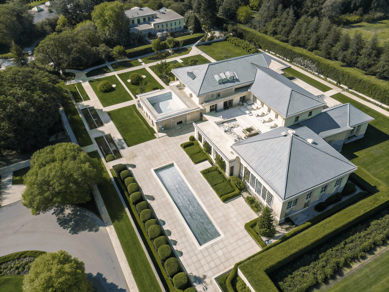 Expansive luxury estate grounds with manicured gardens and architectural elegance